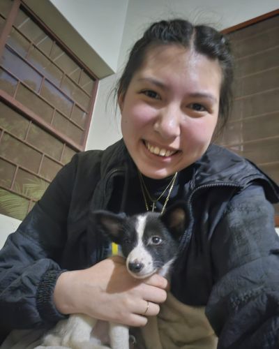 Grace holds a small dog while serving in West Africa