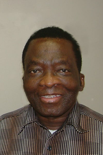 a portrait photo Ernest Mcambi smiling