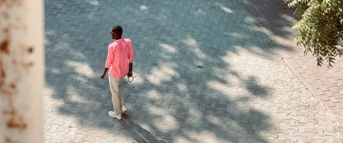 A man walks down a cobbled street in Somalia