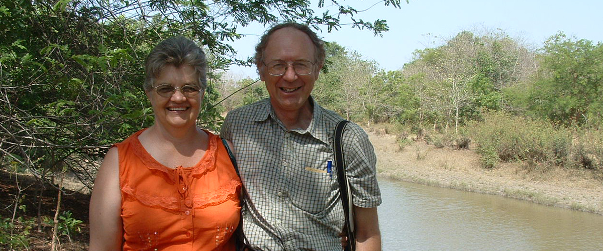 Steven and Lorraine standing outside near a river.