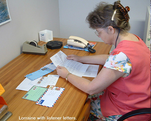photo of Lorraine at a desk with text reading: Lorraine with listener letters