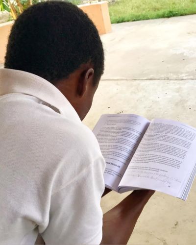 A member of an Every Man a Warrior group in Haiti reads from his curriculum.