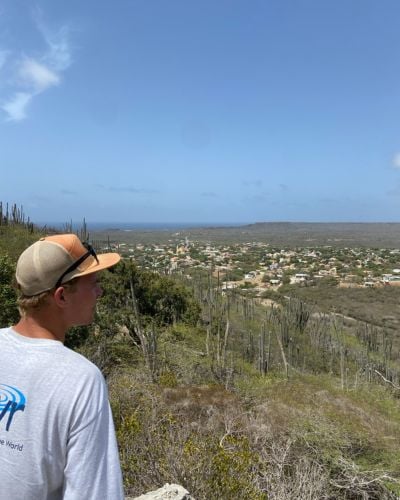 Ryan wearing a TWR t-shirt overlooking the island of Bonaire. 
