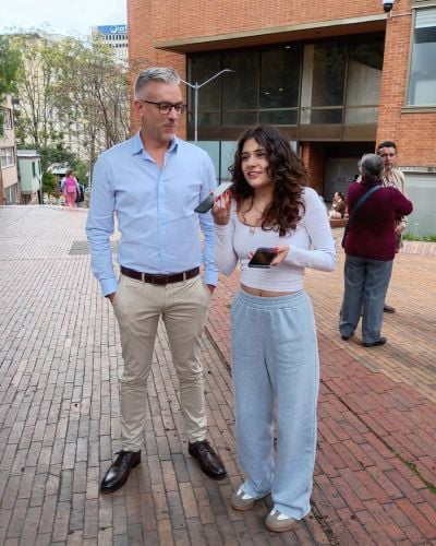 A young woman interviews TWR President and CEO, Andy Schick, while he and a group of TWR staff explored the city of Bogotá.