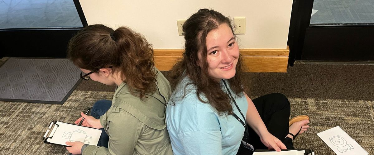 Kristina (right) and fellow intern, Veronica (left), participate in a community exercise during TWR's intern orientation.