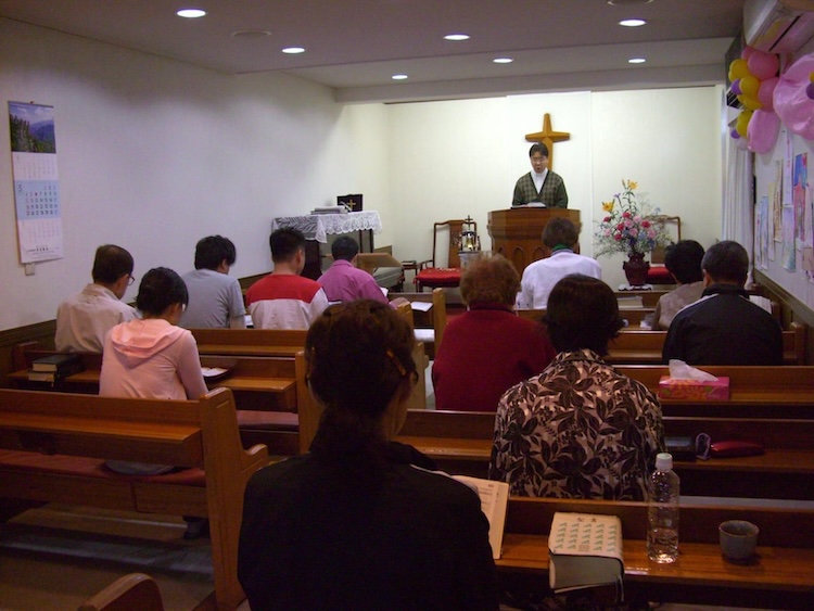 Pastor Park addresses a congregation from the pulpit