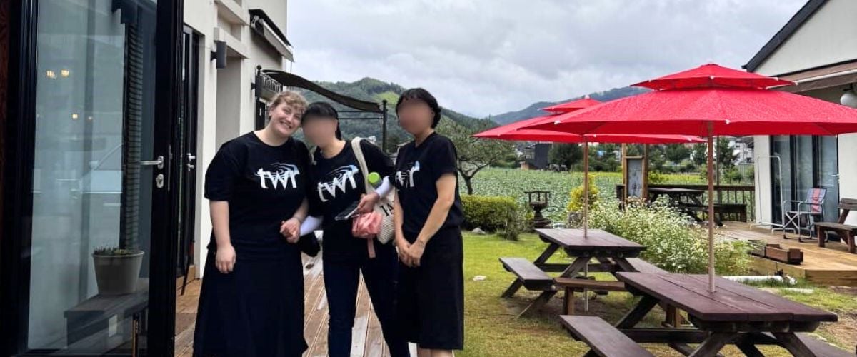 Lydia (left) stands with two members of TWR's team in Korea. 