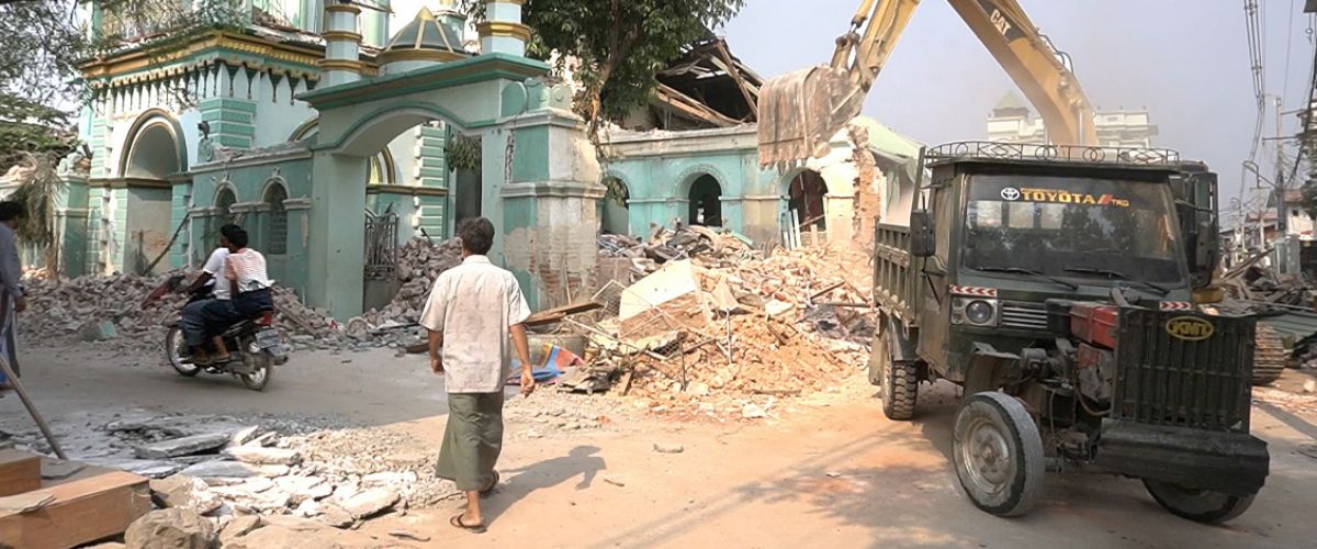 Ruined buildings stand half-collapsed amidst the wreckage of a 7.7-magnitude earthquake in Myanmar.