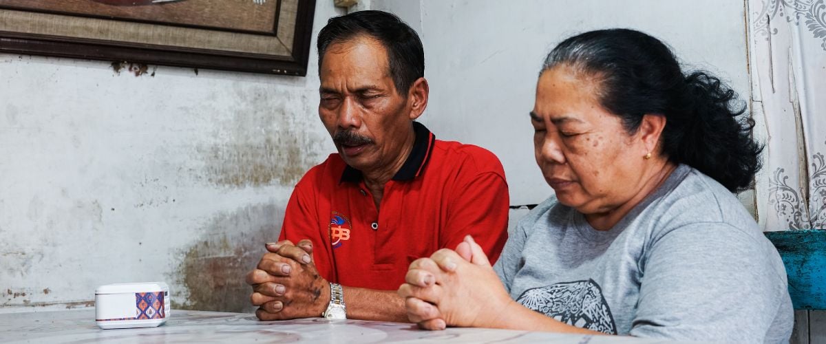 Man and woman praying together in Indonesia. Indonesia earthquake response Christian missions