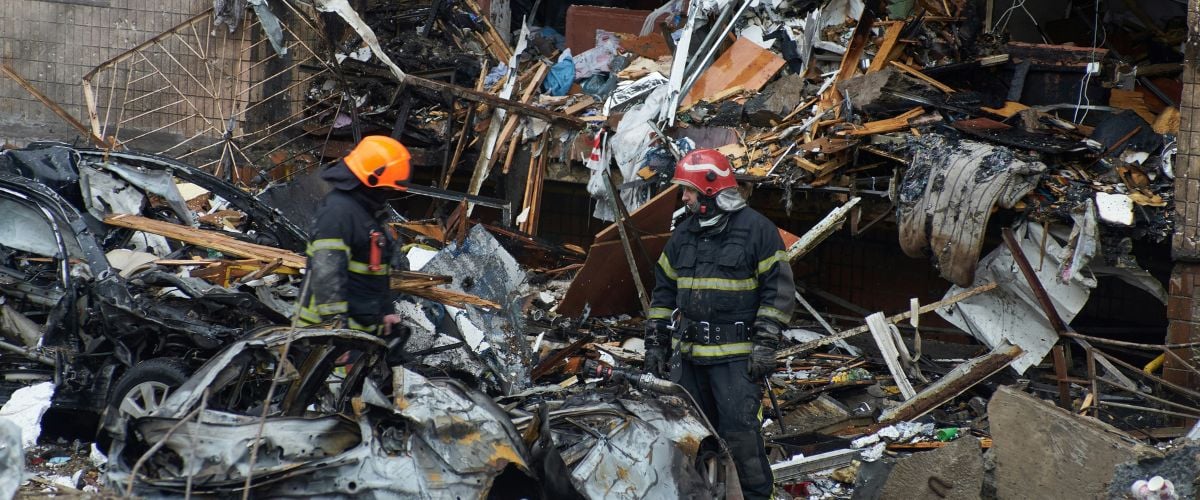 A pair of firefighters sift through rubble, the result of a Russian attack, in Ukraine. 
