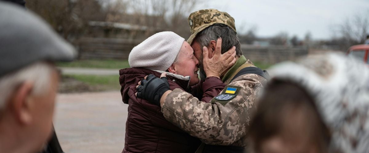 A couple tearfully embraces after reuniting amidst the Ukraine war. 