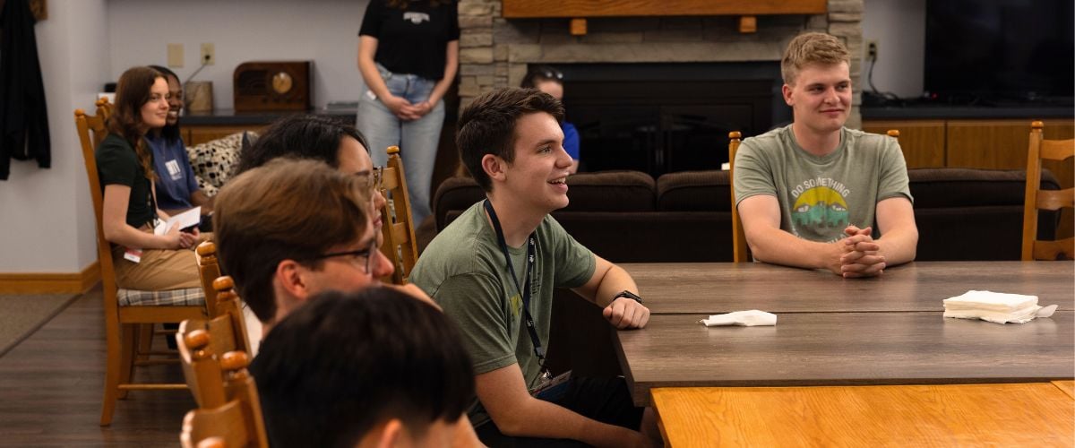 Jeffrey listens to a speaker during intern orientation