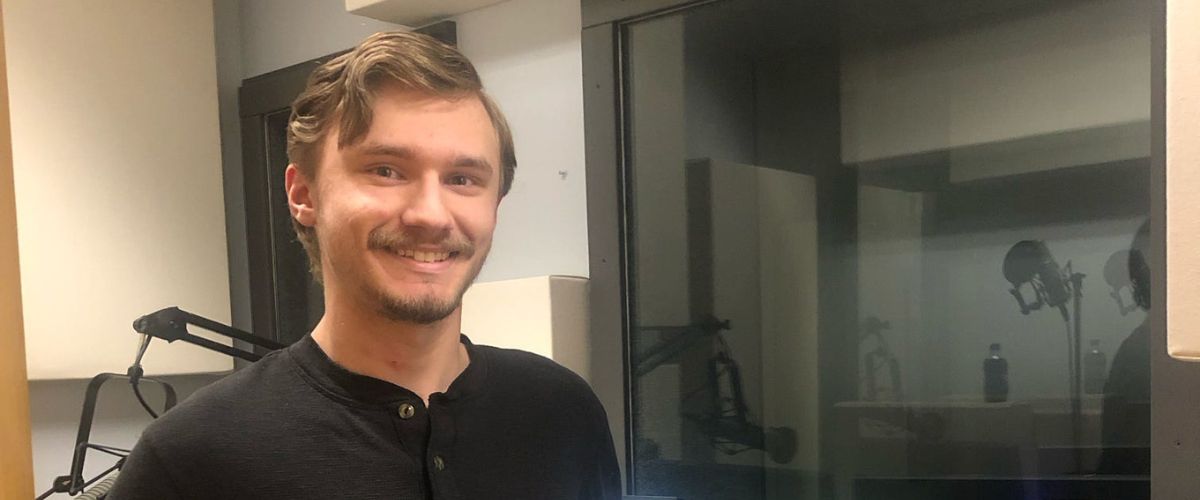 Bryson stands in a TWR audio studio during his summer as an intern for the Global Content department.