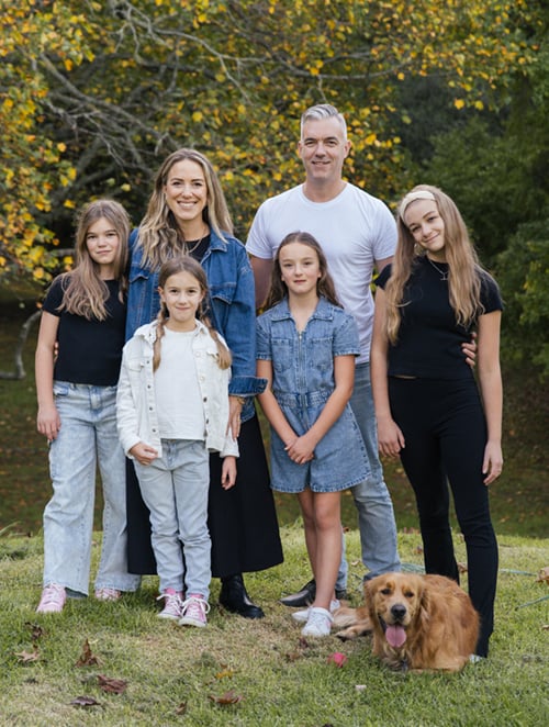 Kate and Andy Schick with their daughters,  from left, Lucia (11), Mila (7), Sadie (9) and  Scarlett (13); Scout (2) poses in front.
