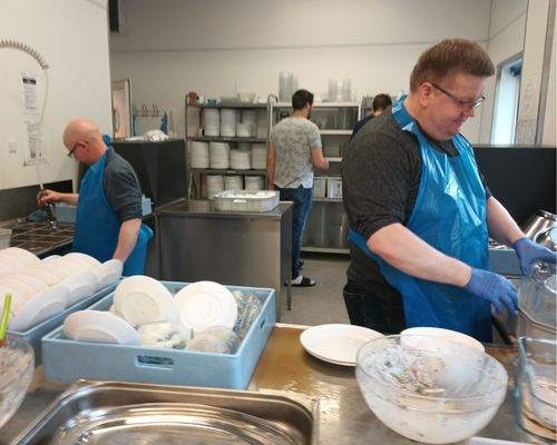 Faroese men, who volunteered to help at the conference, wash the dishes generated by 270 women on Sunday (Sept. 11, 2022) at the Zarepta Conference Center, Faroe Islands. Nikolas Olsen is in front on the right. 