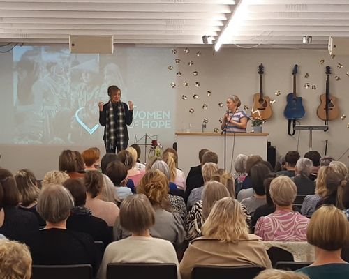 Dr. Peggy Banks, director of TWR Women of Hope, speaks on Saturday (Sept. 10, 2022) to a full room during the women's conference at Zarepta Conference Center on the Faroe Islands. Her interpreter (on the right) is fluent in English, Faroese and Danish and is an expert in Greenlandic, the indigenous language of Greenland.