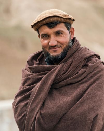A man in Afghanistan looks towards the camera. 